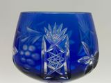 a blue glass with a design on it on a table
