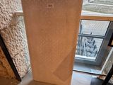 a picture of a mattress sitting on the floor in front of a window