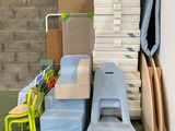 a pile of plastic chairs and a chair in a room