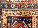 an image of a blue and red rug with a design on it