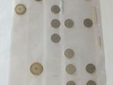 a lot of coins in a plastic bag on a table