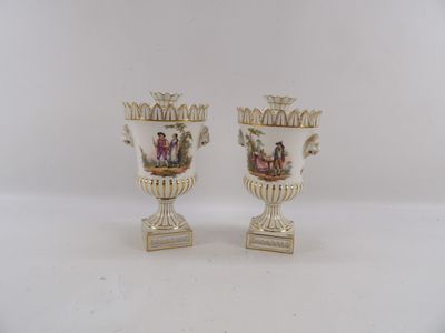 pair of antique porcelain vases with painted scenes on them