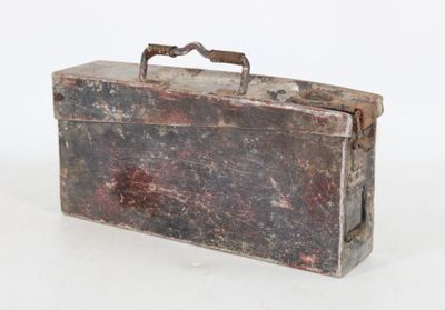 an old metal box with a handle on a white surface