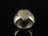 a close up of a diamond ring on a black surface