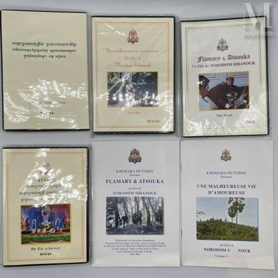several books are on a table with a white wall in the background