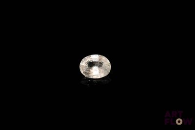 a close up of a white diamond on a black surface