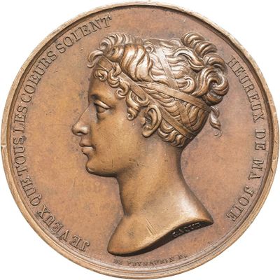 an old bronze medal with a woman ' s head on it