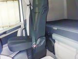 a seat in the back of a van with a laptop on it
