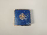 an image of a small blue wallet with a gold emblem on it