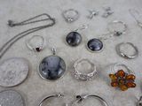 many different types of jewelry displayed on a table
