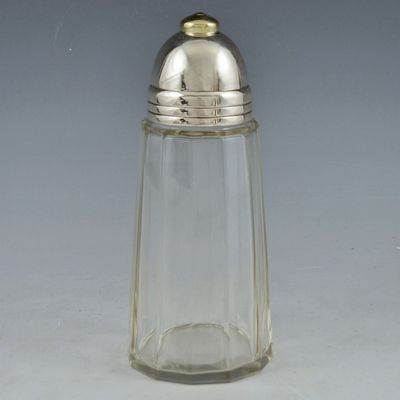 a small glass salt shaker with a silver top