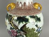 a vase with a bird and flowers painted on it