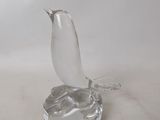 a glass bird that is sitting on top of a table