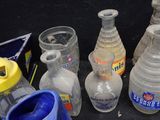 a lot of empty bottles and cups on the table
