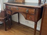 a small desk with a chair in the corner of the room