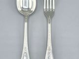 two silver spoons and a fork on a gray surface