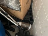 a box and a vacuum in the corner of a room