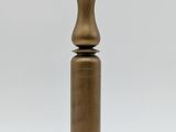 an antique brass pepper mill on a wooden base