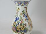 a white vase with a blue and white design on it