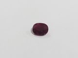 an oval cut ruby gems on a white surface