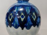 un vase bleu et blanc posé sur une table