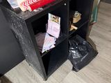 a black shelf with a bunch of items on top of it