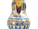 a blue and white vase with a lion head on it