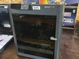 two ovens that are sitting on a shelf in a store