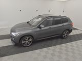 a picture of a grey bmw suv parked in a garage