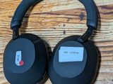 a pair of headphones sitting on top of a wooden table