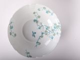 a white bowl with blue flowers and a bird on it