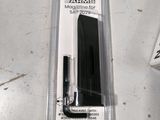 two pens and a pen holder sitting on a table