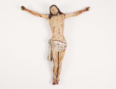 a wooden statue of jesus on the cross on a white background