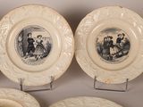 three plates with pictures of people on them are on display