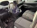 the interior of a car with the door open and the driver ' s seat down