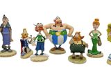 seven figurines of different characters on a white background