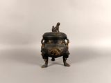 an antique bronze incense pot with a monkey on top of it