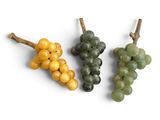 three different types of grapes on a white surface