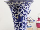 a blue and white vase with a bird on it