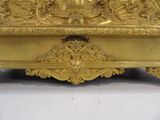 a gold clock that is sitting on a table
