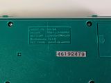 a close up of a green electronic device on a table