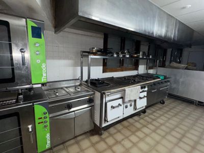 a large kitchen with a lot of stainless steel appliances