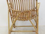 a chair made out of bamboo sticks on the floor