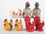 five figurines of chickens and roosters sitting on a shelf