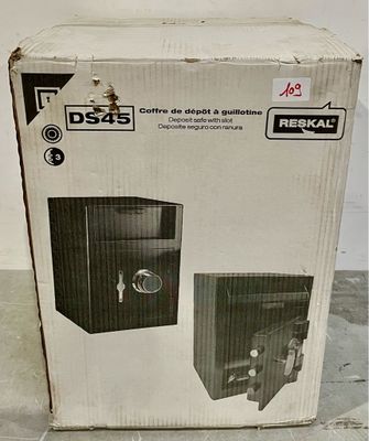 packaging of a box with a safe inside of it sitting on a tile floor