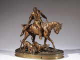 bronze statue of a man on a horse with a dog