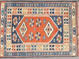 an orange, blue and white rug with a diamond design