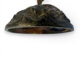 a bronze statue of a cat sitting on top of a rock