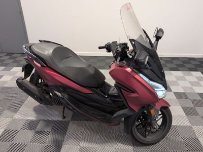 a red motorcycle that is parked on a checkered floor