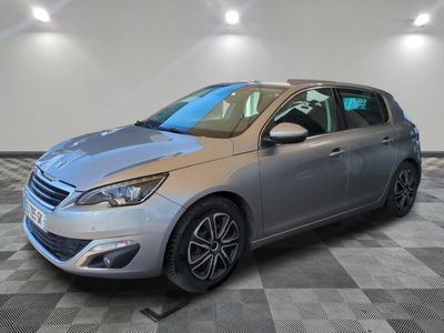 a silver car is parked on a checkered floor in a garage